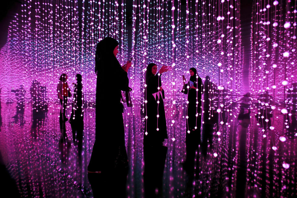 Emirati women takes a selfie at an exhibition called Edge of Government at the Museum of the Future of the World Government Summit in Dubai, United Arab Emirates, Monday, Feb. 12, 2018. (AP Photo/Kamran Jebreili)