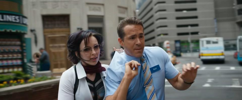 A man and woman crossing a street