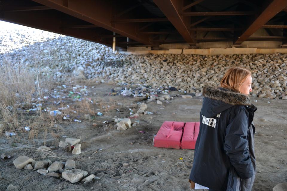 Courtney Mathis, an outreach worker for Wellspring, looks for unsheltered residents underneath the White River bridge on Ind. 39.