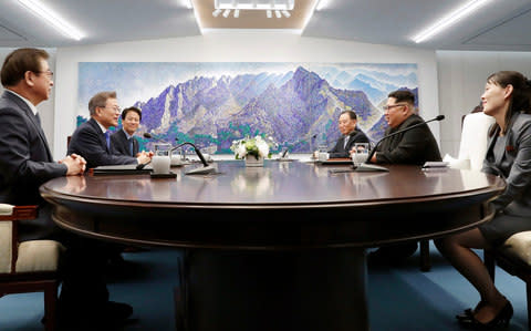 North Korean leader Kim Jong Un, second from right, talks with South Korean President Moon Jae-in - Credit: AP