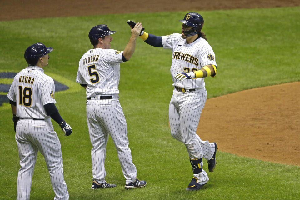 Milwaukee Brewers' Jacob Nottingham (26) celebrates with teammates after hitting a grand slam during the fourth inning of a baseball game against the Kansas City Royals, Friday, Sept. 18, 2020, in Milwaukee. (AP Photo/Aaron Gash)