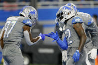 Detroit Lions running back D'Andre Swift (32) celebrates his two-yard touchdown run with Quintez Cephus (87) in the second half of an NFL football game against the Baltimore Ravens in Detroit, Sunday, Sept. 26, 2021. (AP Photo/Duane Burleson)