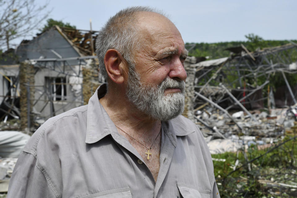 A man reacts as he stands next to a building damaged by an overnight missile strike in Sloviansk, Ukraine, Wednesday, June 1, 2022. (AP Photo/Andriy Andriyenko)