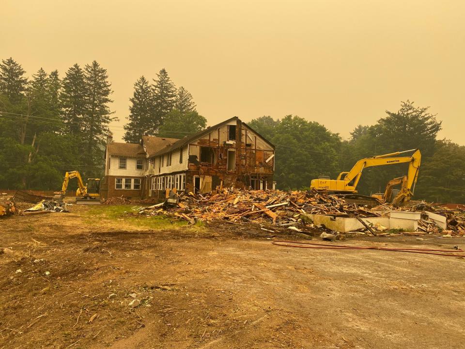 Hazy skies over Monroe County due to Canadian wildfires overshadow the demolition process at Tannersville Inn on June 7, 2023.