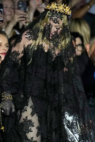 <p>AP Photo/Antonio Calanni</p> Madonna attends Dolce & Gabbana's Milan Fashion Week 2024 show