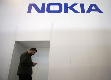 A man walks past the Nokia stand while attending the Mobile World Congress in Barcelona March 5, 2015. REUTERS/Albert Gea