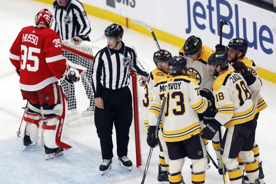 Boston Bruins' Pavel Zacha (18) celebrates his goal on Detroit Red Wings' Ville Husso (35) with Charlie McAvoy (73), Brad Marchand (63), James van Riemsdyk (21) and David Pastrnak (88) during the first period of an NHL hockey game Saturday, Oct. 28, 2023, in Boston. (AP Photo/Michael Dwyer)