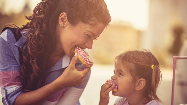 Mother and daughter enjoying donuts