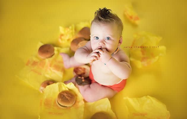 Liam indulges in a McDonald's cheeseburger. Photo: Laura Stennett Photography