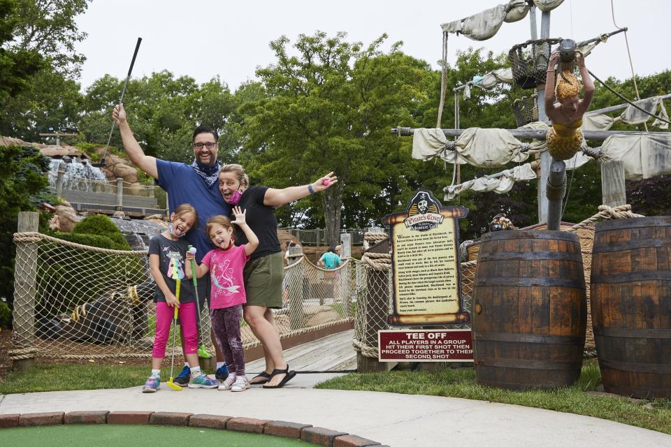 The Pires family, from left, Anjolie, David, Delilah and Monika, tee off at Pirate's Cove Adventure Golf in West Yarmouth on their first visit to Cape Cod.