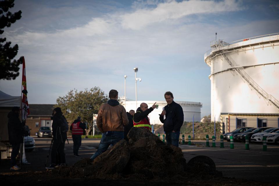 A CGT Trade Union member (C) gestures as he speaks to journalists at the ExxonMobil refinery site, in Port-Jerome-sur-Seine, near Le Havre, northwest France, October 12, 2022. / Credit: LOU BENOIST/AFP/Getty