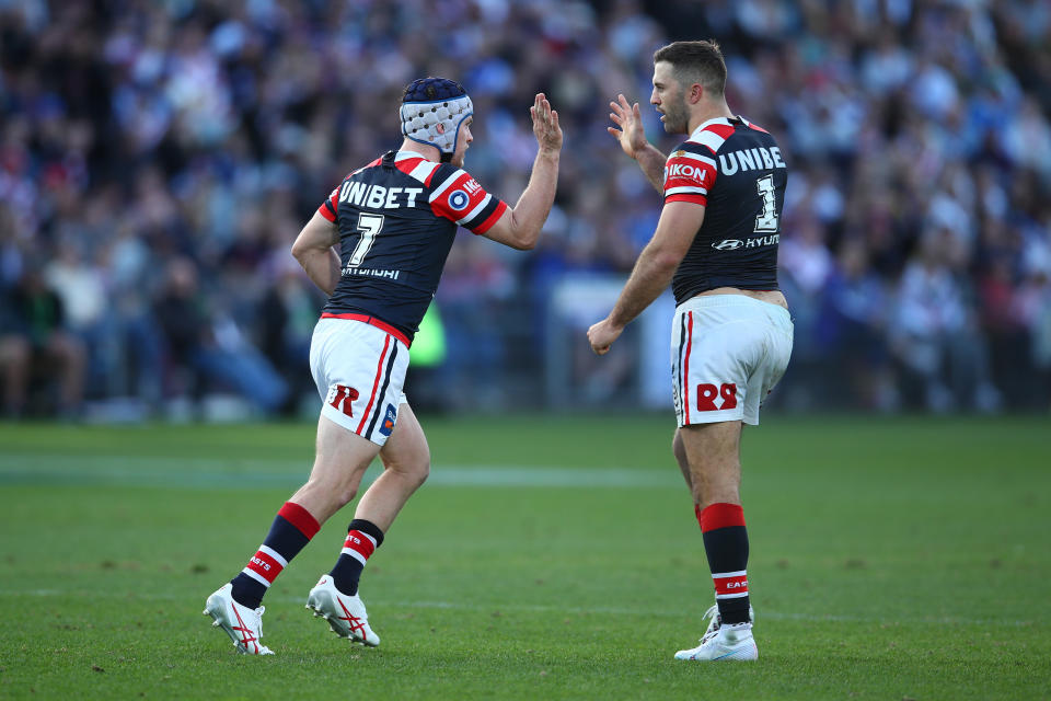 Luke Keary hive-fives teammate James Tedesco.