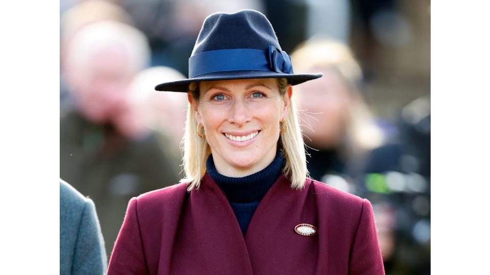 Zara Tindall in burgundy coat and blue hat