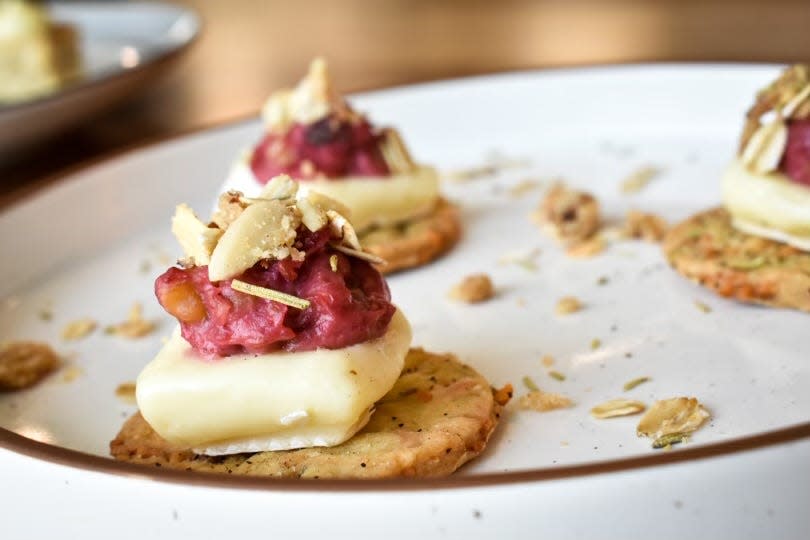 The "wine and cheese" appetizer for Anna Ross and Caroline McGinley's dessert dinner: homemade rosemary crackers topped with Brie cheese, walnut cranberry sauce and oatmeal cookie crumble.