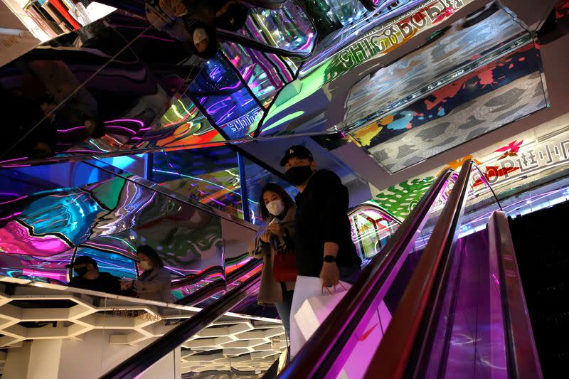 People wearing face masks are seen inside a shopping mall in Beijing, as the spread of the novel coronavirus disease (COVID-19) continues in the country