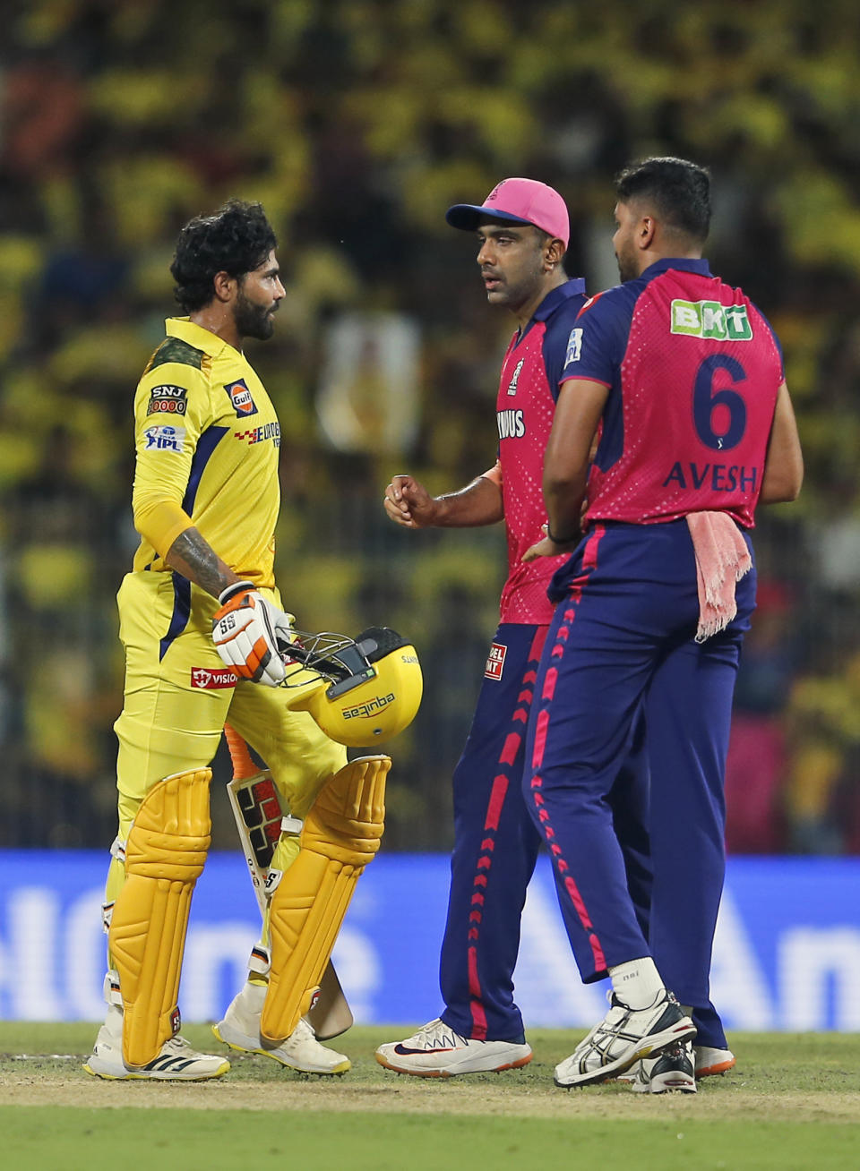 Chennai Super Kings' Ravindra Jadeja, left, argues with Rajasthan Royals' Ravichandran Ashwin, center, after he is give out for obstructing the field during the Indian Premier League cricket match between Chennai Super Kings and Rajasthan Royals in Chennai, India, Sunday, May 12, 2024. (AP Photo/R. Parthibhan)