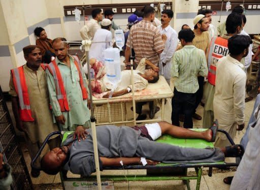 Pakistanis, injured during shooting in Karachi, lie on hospital stretchers at a hospital in the city. Violence between ethnic groups and criminal gangs killed 39 people in Pakistan's financial capital of Karachi, police said Thursday, as the government again struggled for solutions to the unrest