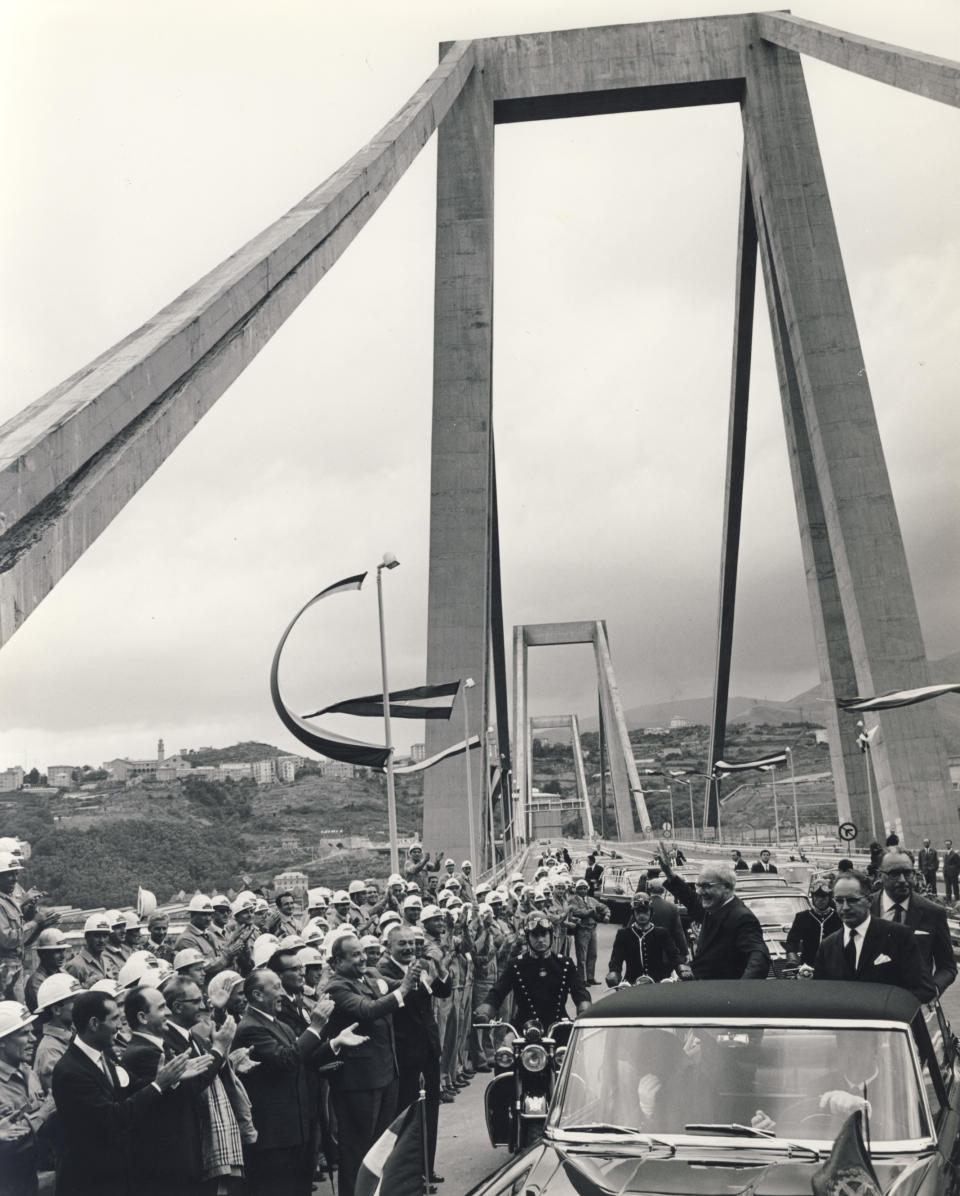 En esta fotografía del 4 de septiembre de 1967, el entonces presidente de Italia Giuseppe Saragat, parado en el auto saludando, inaugura el viaducto Polcevera, también conocido como el puente Morandi, después de ser construido en Génova, Italia. (Autostrade per l'Italia vía AP)