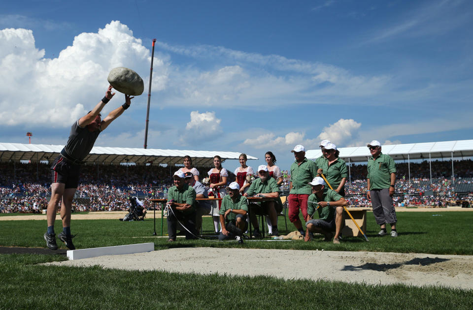 Schuler throws the Unspunnen stone during the Federal Alpine Wrestling Festival