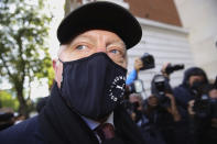 Retired German tennis player Boris Becker, foreground, arrives at Westminster Magistrates Court in London, after being declared bankrupt and accused of not complying with obligations to disclose information, Thursday, Sept. 24, 2020. Becker is being prosecuted by the Insolvency Service. (Aaron Chown/PA via AP)