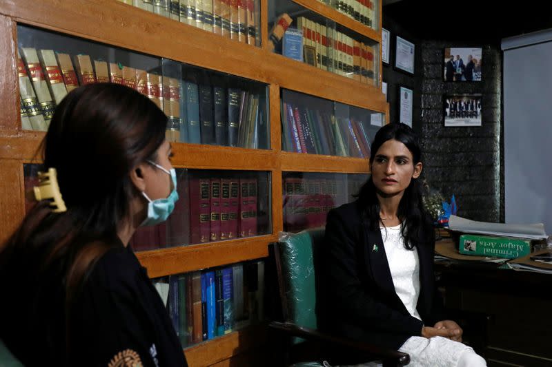 Nisha Rao, 28, a transgender woman who became country's first practicing lawyer, listens to one of her clients at office in Karachi,