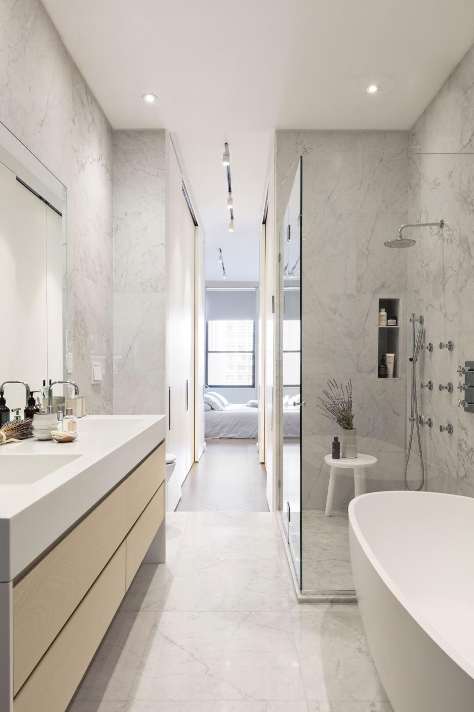 The master bath is dominated by richly veined Carrara marble.