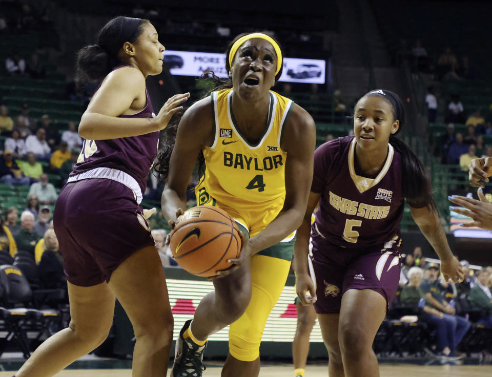 Baylor center Queen Egbo, center, drives between Texas State forward Chelsea Johnson, left, and guard Jo'Nah Johnson, right, in the first half of an NCAA college basketball game, Tuesday, Nov. 9, 2021, in Waco, Texas. (Rod Aydelotte/Waco Tribune-Herald via AP)