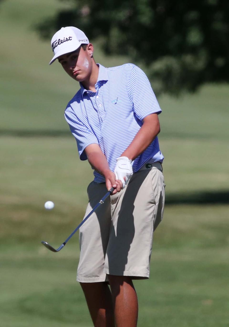 Bradley Chill of Columbia Station chips onto the 18th green during the Hudson Junior Golf Tournament at the Country Club of Hudson in Hudson on Thursday. He won the tournament.
