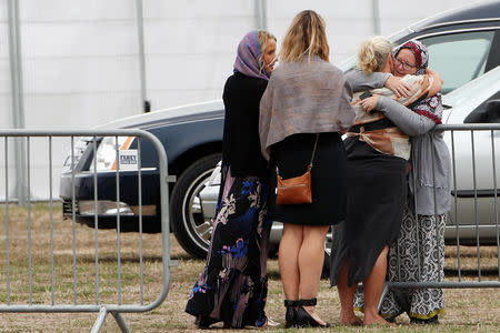 Relatives and other people arrive to attend the burial ceremony of the victims of the mosque attacks, at the Memorial Park Cemetery in Christchurch, New Zealand March 21, 2019. REUTERS/Edgar Su