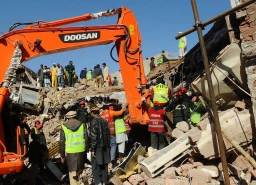 Pakistani rescue workers continue their search for victims from the debris of a collapsed building in Lahore on Tuesday, as the death toll rises to 19. Emergency teams spent night and day digging through the debris with their bare hands