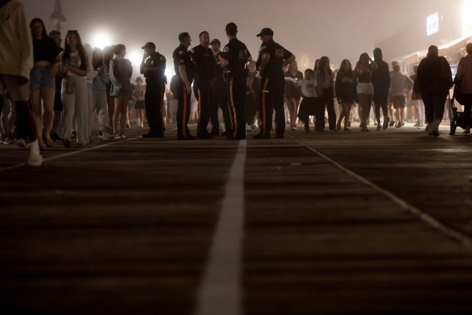 Police watch the crowds on the boardwalk in Ocean City, N.J., on Memorial Day weekend, Sunday, May 26, 2024 (© 2024 Copyright The Philadelphia Inquirer)