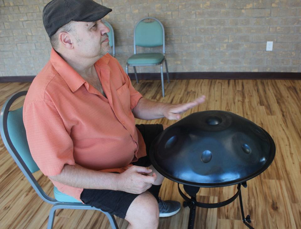 Ross Long plays the handpan, a pounded steel drum, adding a relaxing and calming musical tone to the exercise class at the Senior Resource Development Agency on Thursday.