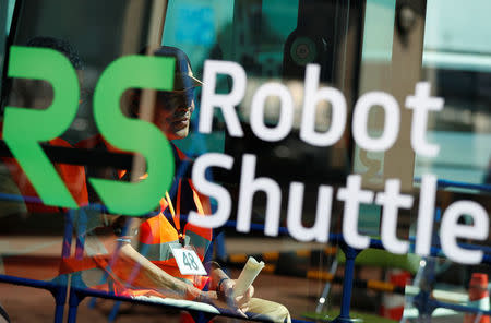 Local residents are seen inside Robot Shuttle, a driver-less, self driving bus, developed by Japan's internet commerce and mobile games provider DeNA Co., during an experimental trial with a self-driving bus in a community in Nishikata town, Tochigi Prefecture, Japan September 8, 2017. REUTERS/Issei Kato