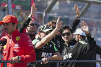 Sauber driver Zhou Guanyu, right, of China and teammate Valtteri Bottas of Finland wave during the drivers parade ahead of the Australian Formula One Grand Prix at Albert Park, in Melbourne, Australia, Sunday, March 24, 2024. (AP Photo/Scott Barbour)