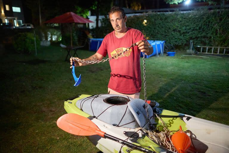 Federico Gómez muestra su kayak y el ancla que utiliza