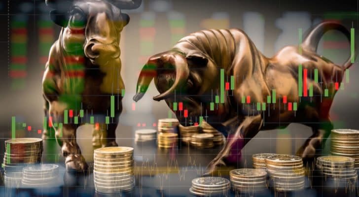 A digital image of a bronze bull and bear overlaid with a technical chart and images of coins.