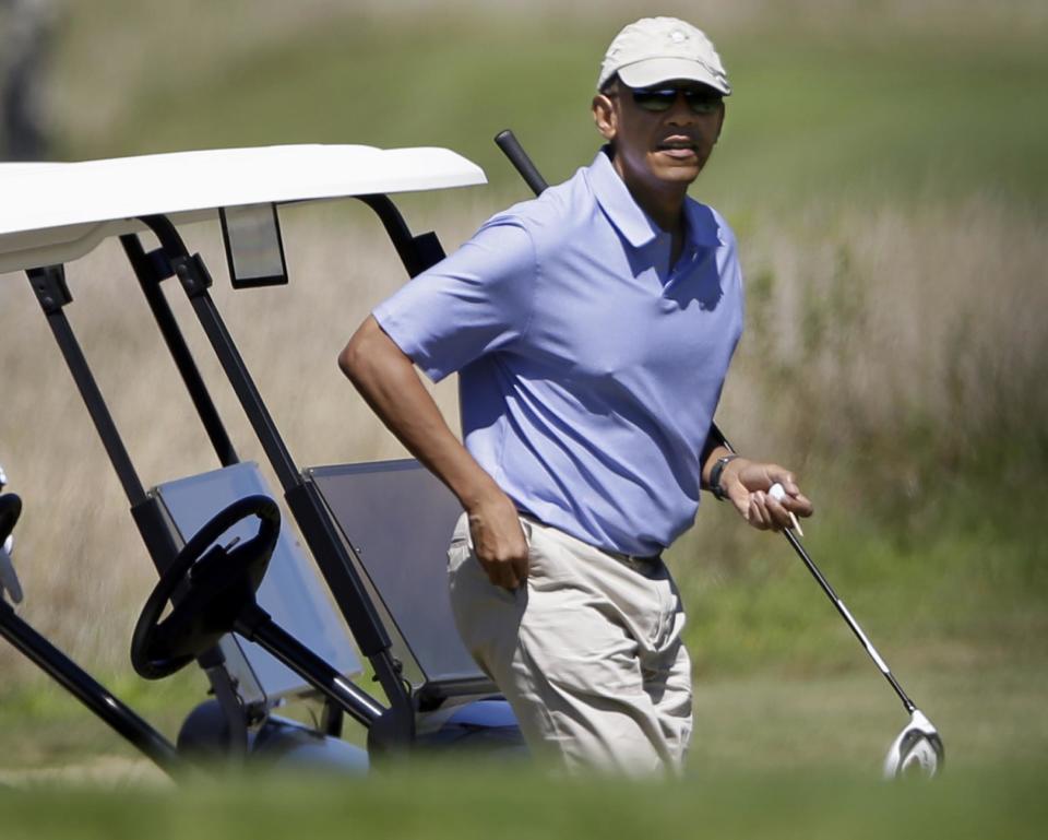 President Barack Obama walks toward the tee while golfing at Vineyard Golf Club in Edgartown, Mass., on the island of Martha's Vineyard Wednesday, Aug. 14, 2013. (AP Photo/Steven Senne)