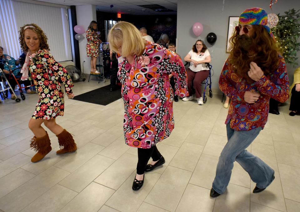 Mable H. Kehres community manager Kim Miller, assistant community manager Renee Cicero and maintenance technician Kit Northingon, who was a Bedford graduate with Class of 1981, open up the dancing to "My Eyes Don't Cry" by Stevie Wonder June 2 at Mable Kehres' first senior prom with a disco theme.