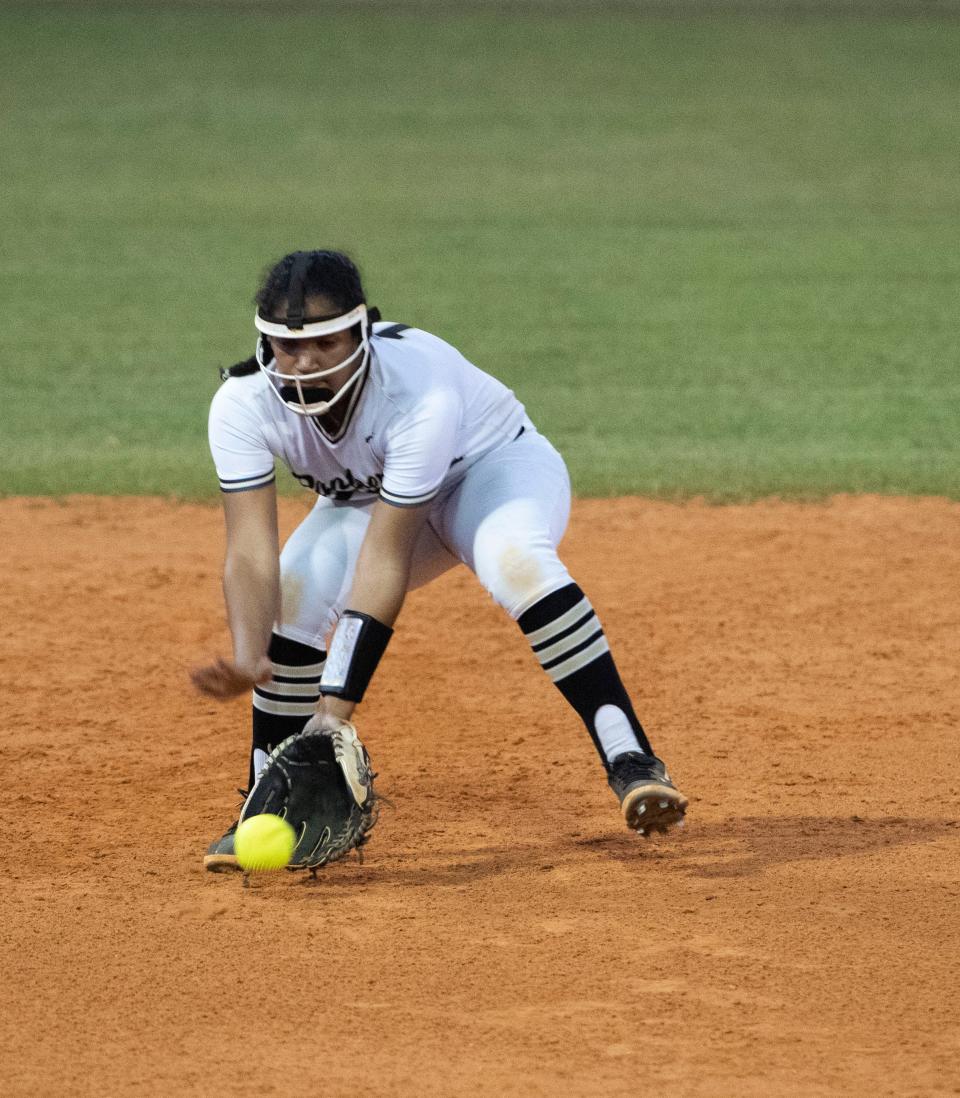 Milton High School's Laila Manning scoops up the ground ball to short for an easy out during Thursday's District 1-5A softball game against Gulf Breeze. 