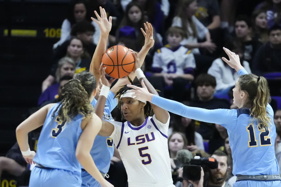 LSU forward Sa'Myah Smith (5) tries to pass around Kent State guard Corynne Hauser (3) and forward Jenna Batsch (12) in the second half an NCAA college basketball game in Baton Rouge, La., Tuesday, Nov. 14, 2023. LSU won 109-79. (AP Photo/Gerald Herbert)
