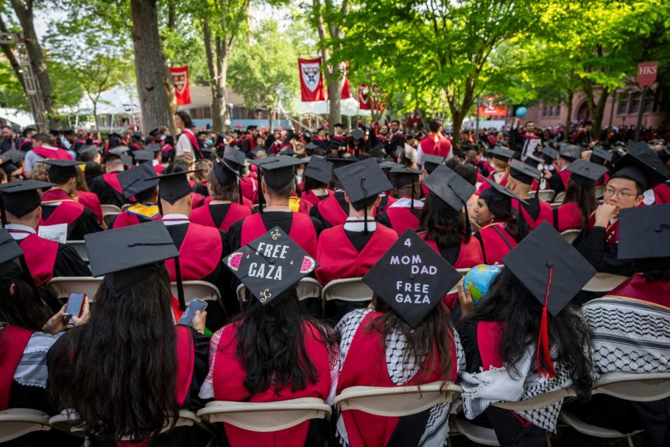 Graduating students with messages supporting Gaza on their mortarboards during commencement in Harvard Yard (AP)