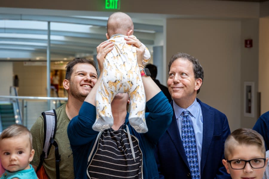A family holds their baby at the ribbon-cutting ceremony for the Utah Pregnancy After Loss program. (Courtesy of University of Utah Health)