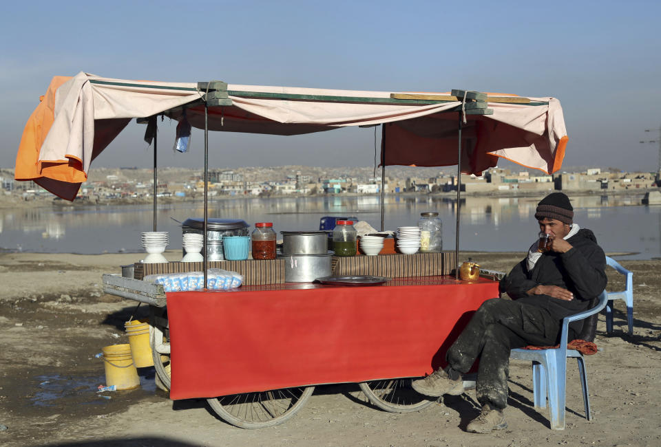 FILE - In this Jan. 28, 2019 file photo, an Afghan street vendor waits for customers on the outskirts of Kabul, Afghanistan. In a Thursday, March 28, 2019 report the Special Inspector General for Afghan Reconstruction, a U.S. watchdog, said that Afghanistan will remain dependent on international donors and foreign help even after a peace deal with the Taliban is reached. The report identified main high-risk areas including the sluggish economy. (AP Photo/Rahmat Gul, File)