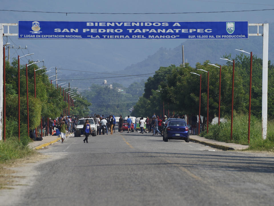 Migrants, mostly from Venezuela, arrive at a camp where Mexican authorities will arrange permits for their continued travel north, in San Pedro Tapanatepec, Oaxaca, Mexico Wednesday, Oct. 5, 2022. As migrants, especially Venezuelans, struggle to come to terms with a new U.S. policy discouraging border crossings, the town of San Pedro Tapanatepec is unexpectedly playing host to over 10,000 migrants camped far from the U.S. border. (AP Photo/Marco Ugarte)