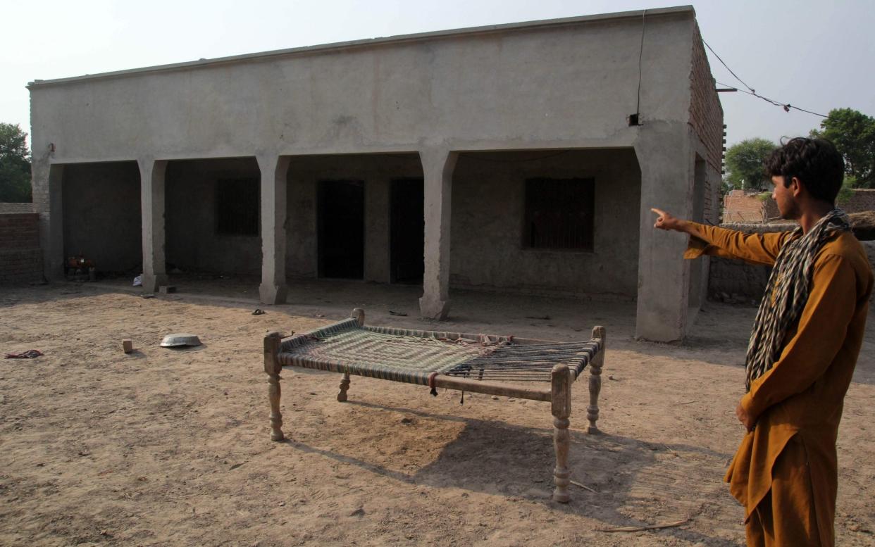 Pakistani villager points to a house where a teenage girl was raped in the neighbourhood of Raja Ram - AFP