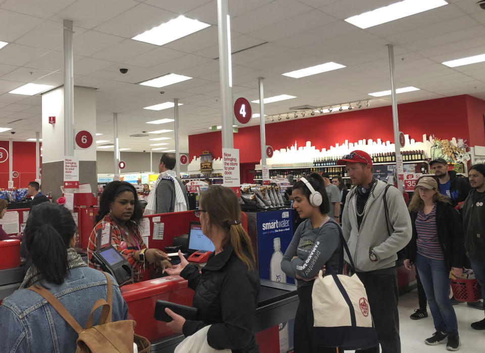 Customers wait on a long check out line at a Target store in San Francisco on Saturday, June 15, 2019. Target suffered a technological glitch that stalled checkout lines at its stores worldwide Saturday, exasperating shoppers and eating into sales at a prime time for retailers. The outage periodically prevented Target's cashiers from scanning merchandise or processing transactions. Self-checkout registers also weren't working at times, causing massive lines in some stores. (AP Photo/Michael Liedtke)