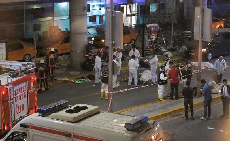 Forensic experts work outside the airport. Photo: Reuters