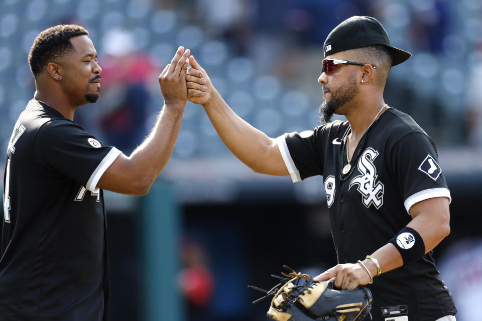 Chicago White Sox first baseman Jose Abreu, right, and Eloy Jimenez, left, celebrate a win over the Cleveland Guardians in a baseball game, Thursday, Sept. 15, 2022, in Cleveland. (AP Photo/Ron Schwane)