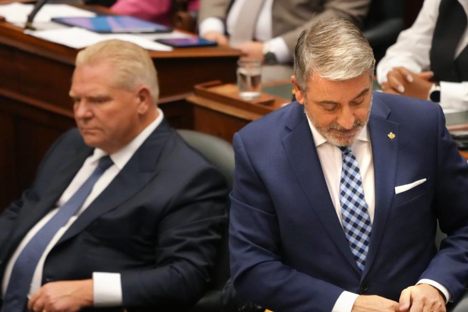 Municipal Affairs and Housing Minister Paul Calandra, right, stands next to Ontario Premier Doug Ford in the Legislature in Toronto on Oct. 25, 2023. 