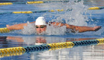 Michael Phelps competes in the 100-meter butterfly final during the Arena Grand Prix swim meet, Thursday, April 24, 2014, in Mesa, Ariz. Ryan Lochte won, and Phelps finished in second place. He was competing for the first time since the 2012 London Olympics. (AP Photo/Matt York)